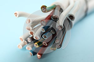 Many electrical wires on light blue background, closeup