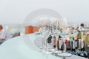 Many empty glass on counter at rooftop bar