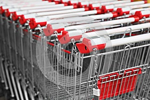 Many empty metal shopping carts, closeup view