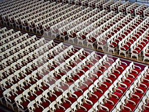 Many empty red chairs in an old concert hall