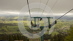 Many empty ski lift chairs in a row close up in the summer