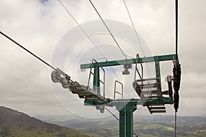 Many empty ski lift chairs in a row close up in the summer