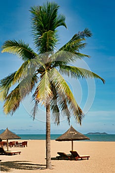 Many empty sun loungers on the deserted beach of Hainan Island.