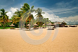 Many empty sun loungers on the deserted beach of Hainan Island.