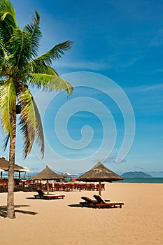 Many empty sun loungers on the deserted beach of Hainan Island.