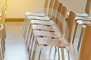 Many empty wooden chairs set neat rows