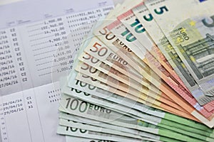 Many euro banknotes and bank account passbook show a lot of transactions. concept and idea of saving money, investment