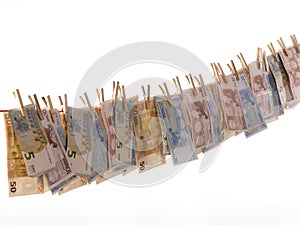 Many euro banknotes on a clothesline