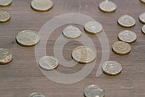 Many euro coins random pattern on a wooden surface