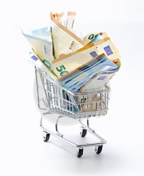 Many European banknotes on a shopping cart symbol of inflation