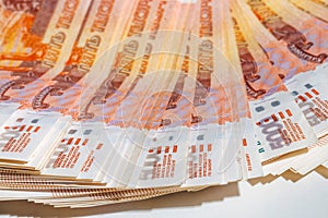 Many five-thousand-rubles bills lie in a fan. Banknotes of 5000 rubles. The Russian national currency. Background of