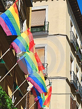 Many flags of gay community hang on the building in Chueca district, downtown Madrid, Spain photo