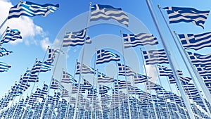 Many Flags of Greece on flagpoles against blue sky.
