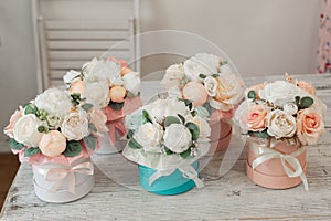 Many flower arrangements. Flowers in round boxes