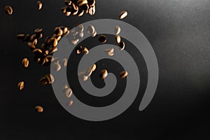 many flying coffee beans on black background