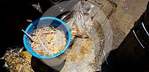 Many food waste in the blue basket on the street