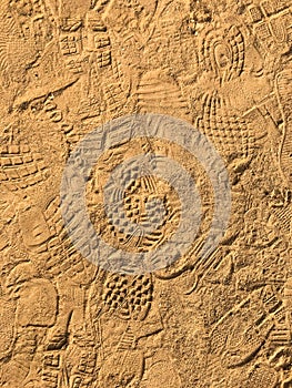 Many footprint on the sand beach texture background.