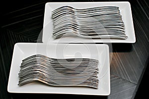 Many forks on a white dish photo