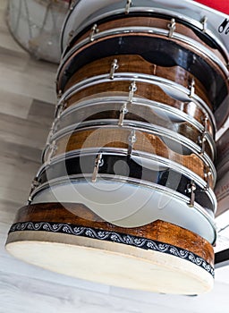 Many frame drums in a row in a music market