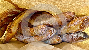 Many fresh baguettes in a paper bag