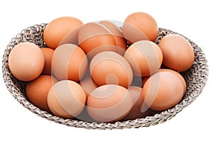 Many fresh chicken eggs in wicker basket