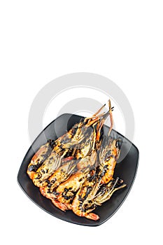 Many fresh river prawns grilled with seafood sauce Placed on a black plate, weighing 1 kg