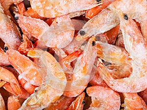 Many frozen boiled red shrimps close up