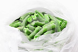 Many frozen bright green beans pods in the package