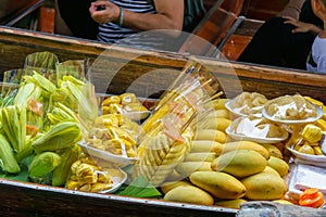 Many fruits  on long-tail boat with floating market, Damnoen Saduak floating market in Ratchaburi near Bangkok, Thailand