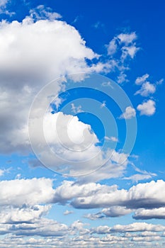 Many furry white clouds in blue sky