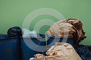 Many Garbages and Full Trash againt the Wall. Pollution Problem from not Waste Sorting Behaviour photo