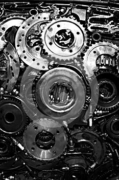 Many gears/ cogwheel/ sprocket-wheel and other parts from cars.