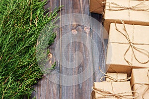 Many gift box on dark rustic wooden background with copy space. Christmas fir tree branches. Christmas conceps