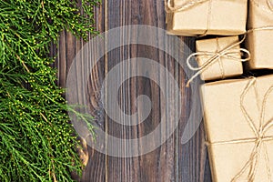 Many gift box on dark rustic wooden background with copy space. Christmas fir tree branches. Christmas conceps