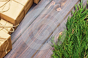 Many gift box on dark rustic wooden background with copy space. Christmas fir tree branches. Christmas conceps