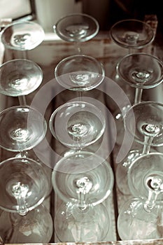 Many glass goblets, dishes close-up