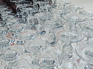 Many glass goblets are upside down