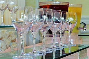 Many glasses of different wine in a row on bar counter