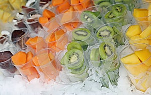 many glasses on ice with fruits