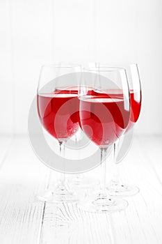 Many glasses of red French wine on a wooden table. Vertical. Con