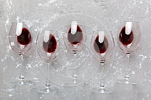 Many glasses of red wine at wine tasting. Concept of red wine on colored background. Top view, flat lay design