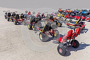 Many go-karts parked on asphalt terrain photo