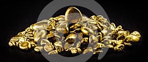 Many gold nuggets on isolated black background, concept of wealth and rare ores