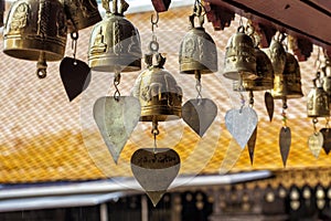 Golden buddhist bells with wishes in sunlight