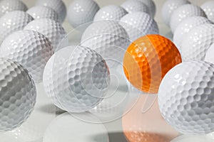 Many golf balls on a glass table