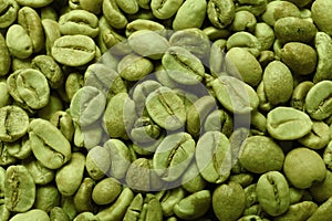 Many green coffee beans as background, top view