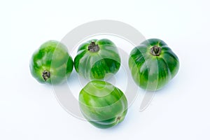 Many green tomato on white background.