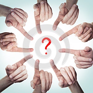 Many hands point to a question mark. Concept the solution of the problem