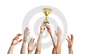 Many hands raised up. Winner is holding trophy in hands. Isolated on white background