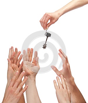 Many hands reaching out for key